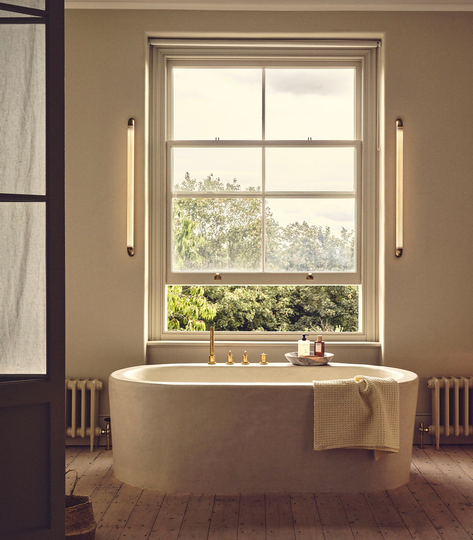 Luxury bathroom wall light in a warm neutral bathroom 