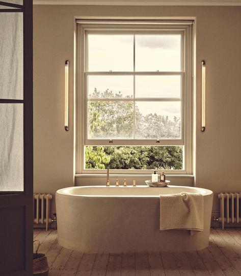 Luxury bathroom wall light in a warm neutral bathroom 