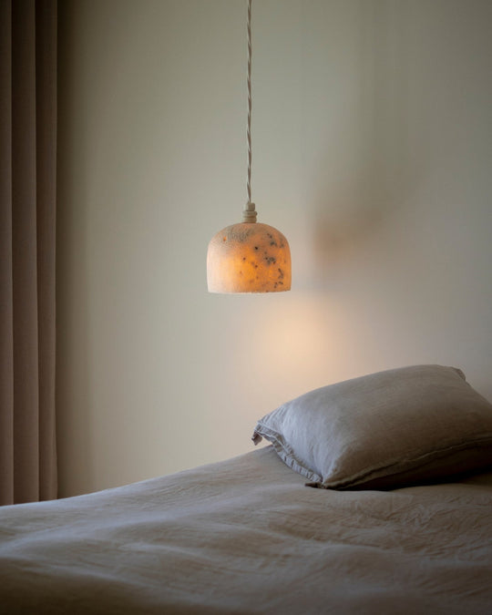 Marovo Fossil Stone hanging pendant in a neutral bedroom 