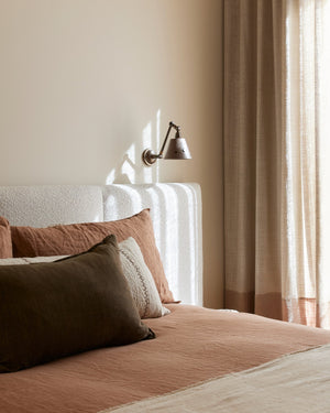 Adjustable Arm Concrete Wall Light in a bedroom