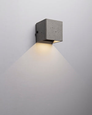 Cement square wall light fixture on a plain background