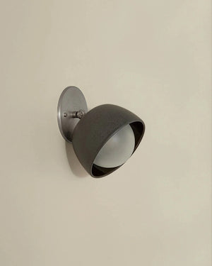 Wall-mounted light fixture on a beige wall
