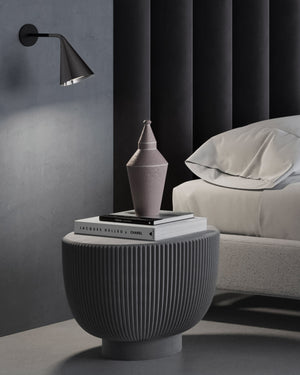 Conical wall light in a bedroom next to the bed