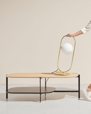 Modern coffee table with a Contemporary Opal Orb Table Lamp on a neutral background