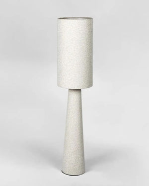 Tall lamp with textured boucle white shade and base on a light gray background | Lighting Collective