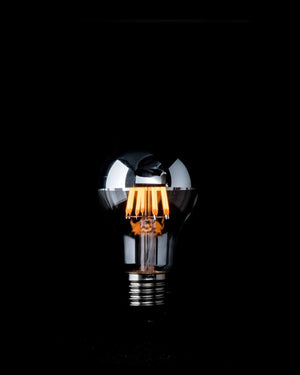 Light bulb with metallic design on a black background
