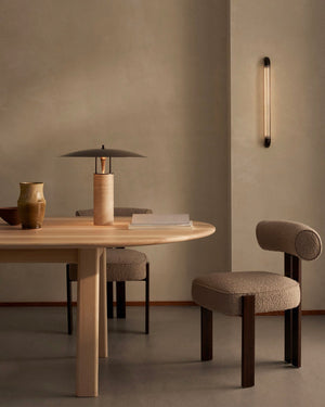 Dining area with wooden table and Elemental Disc Table Lamp in a minimalistic setting