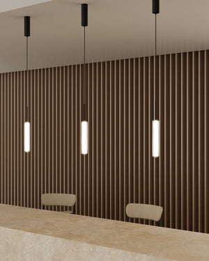 Modern conference room with wooden wall paneling, pendant lights, and a long table.