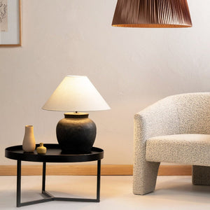 Coastal Ceramic and Linen Table Lamp lit up on a side table | Black