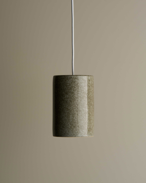 Cylindrical pendant light with a textured finish on a beige background