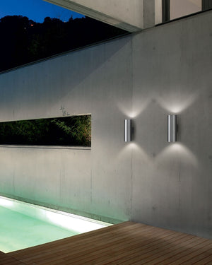 Modern pool area with outdoor light - wooden deck, and night sky.