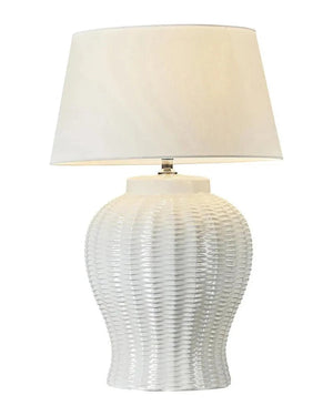 Table lamp with white textured ceramic base and beige lampshade on a white background | Lighting Collective