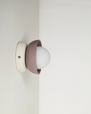 Wall-mounted light fixture with a white bulb on a plain wall Cacao and Cream Colours