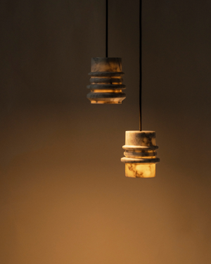 Two White Marble Pendants on a plain background