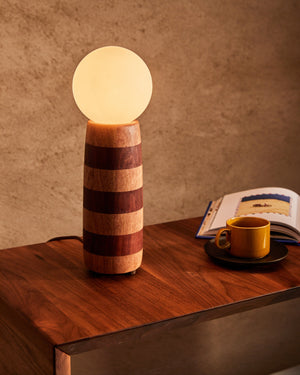 Striped table lamp on a coffee table