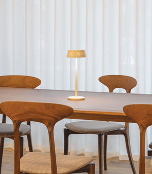 Ceramic potable table lamp on a timber dining table