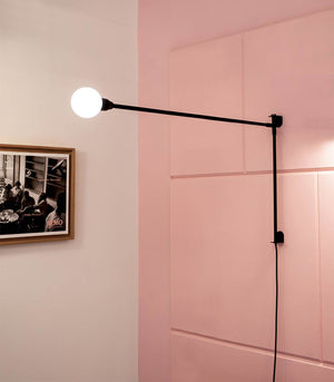 Contemporary Rotating Wall Lamp on a pink wall 