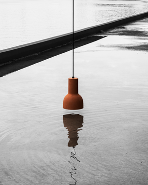 Cast Earth Echo Pendant Over Water