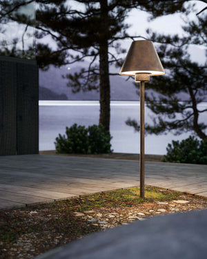 Italian industrial bollard near a pathway of a house by a lake