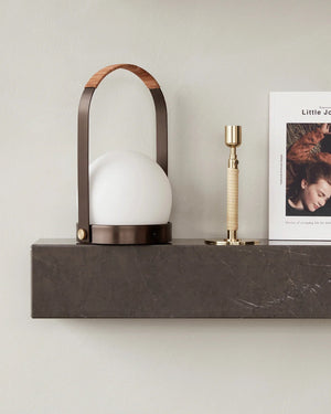 Brass Modern Mobile Lantern on a marble mantlepiece