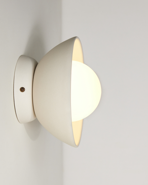 Modern ceramic bell wall light fixture on a plain background