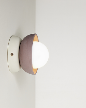 Modern Studio Enti ceramic wall sconce with a cocoa sage finish on a plain background