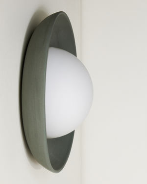 Mani Wall-mounted light fixture with a white bulb and gray casing on a white background
