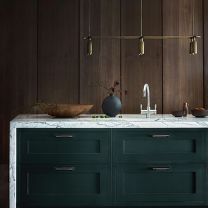 Modern Adjustable 6lt Linear Pendant | Lighting Collective | antique brass finish over a kitchen island made from marble and wood