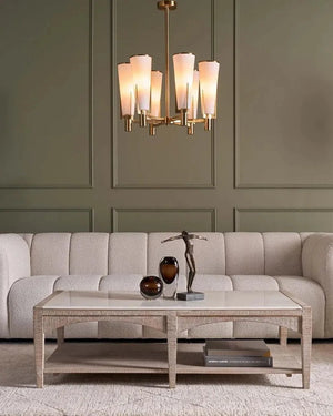 Living room with a beige sofa, coffee table, and chandelier.