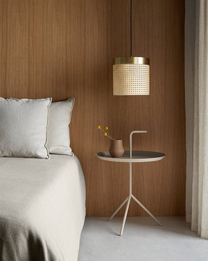 Decorative lamp with wicker design on a wooden wall background