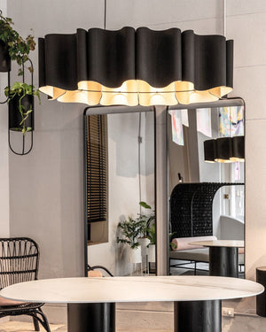 Pleated Oval Timber Pendant hanging in a store