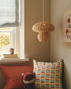 Rattan Mushroom Pendant hanging in the corner of a kids room with light off - Lighting Collective 