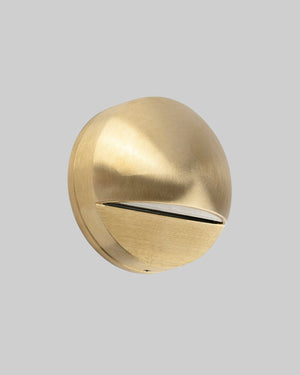 Gold spherical wall light fixture on a white background