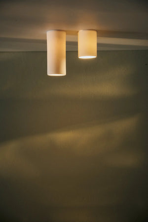 Dusked Eos Ceiling light fixture casting shadows on a wall