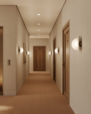 Modern hallway with light fixtures and wooden doors.