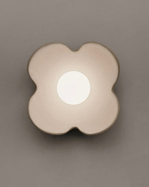 Floral-shaped light fixture on a gray background