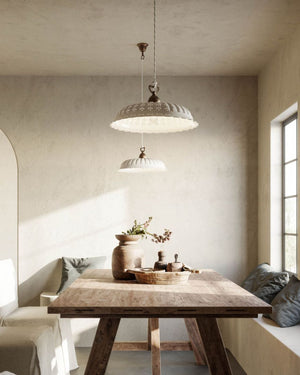 Antique Brass & Ceramic Pendant in a coastal living room over a wooden dining table