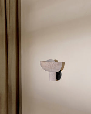 Modern wall-mounted light fixture on a neutral wall