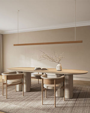 Modern dining room with a timber linear pendant light set above a wood table and chairs