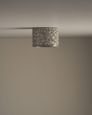 Ceiling light fixture with textured shade on a neutral background