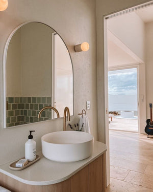 Ceramic wall light styled in a modern coastal bathroom