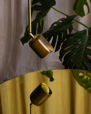 Chartreuse ceramic articulated spot light on top of coffee table