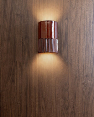 Short curved wall light with indents on the bottom in tommy jam finish
