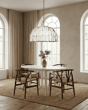 White ceramic dome pendant light hanging above table in a dining room 