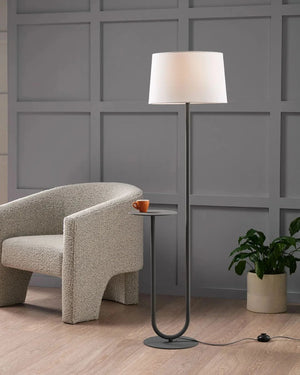 Modern living room with a textured armchair and floor lamp with inbuilt side table.