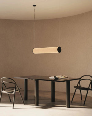 Modern dining table with two chairs and a pendant light in a minimalistic room.