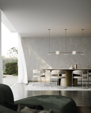 Modern dining area with a table and chairs in a well-lit room.