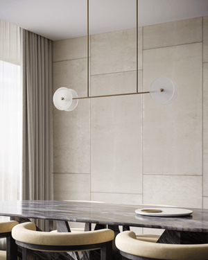 Modern dining room with marble table and chairs against a tiled wall, glass linear pendant