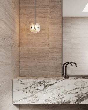 Modern bathroom with marble countertop and wooden wall