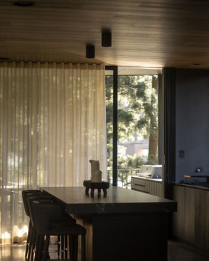 Cylindrical ceiling lights styled in a brutalist kitchen